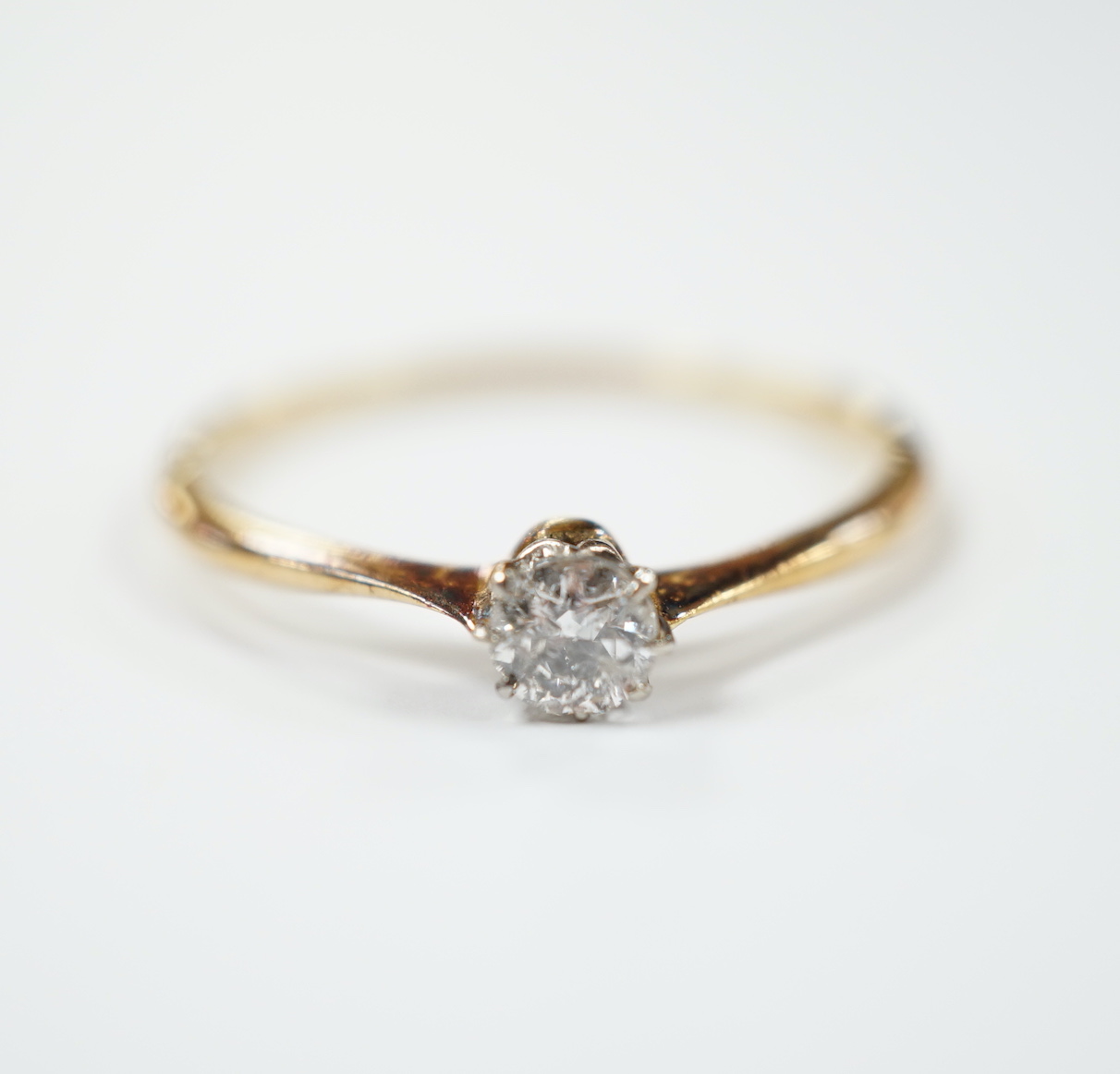 A yellow metal and solitaire diamond set ring, size V, gross weight 2 grams.